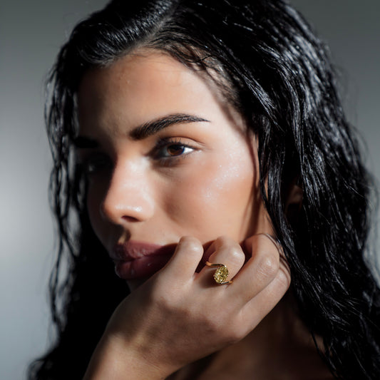 Side view of model wearing Glow Float Ring highlighting 3 carat oval-cut yellow lab-grown diamond