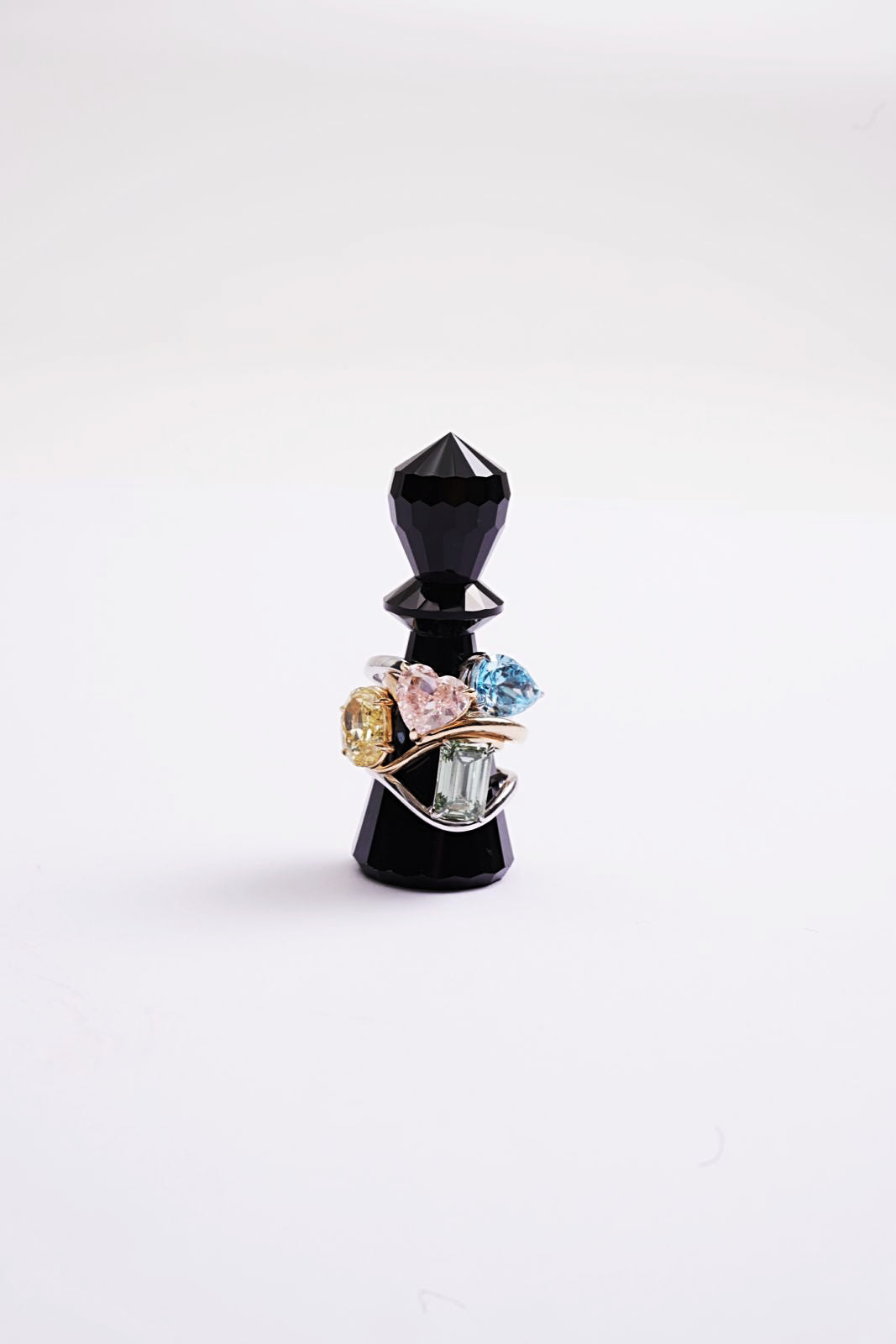 Chess piece with Candy by Shaina floating rings wrapped around it 
