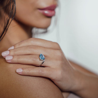 Side view of Drift Float Ring emphasising 3 carat pear-cut blue lab-grown diamond