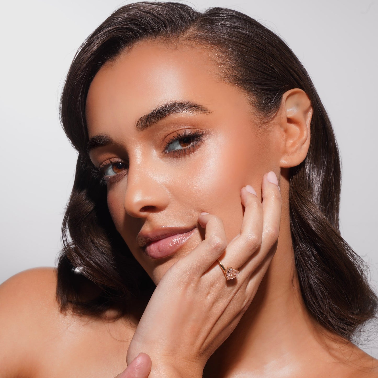 Side profile of model wearing Muse Float Ring highlighting 3 carat heart-cut pink lab-grown diamond