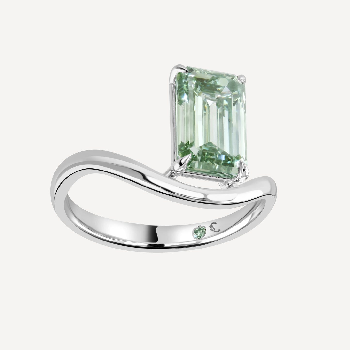 Side view close up of 3 carat green emerald-cut lab-grown diamond Poise Float Ring against white background